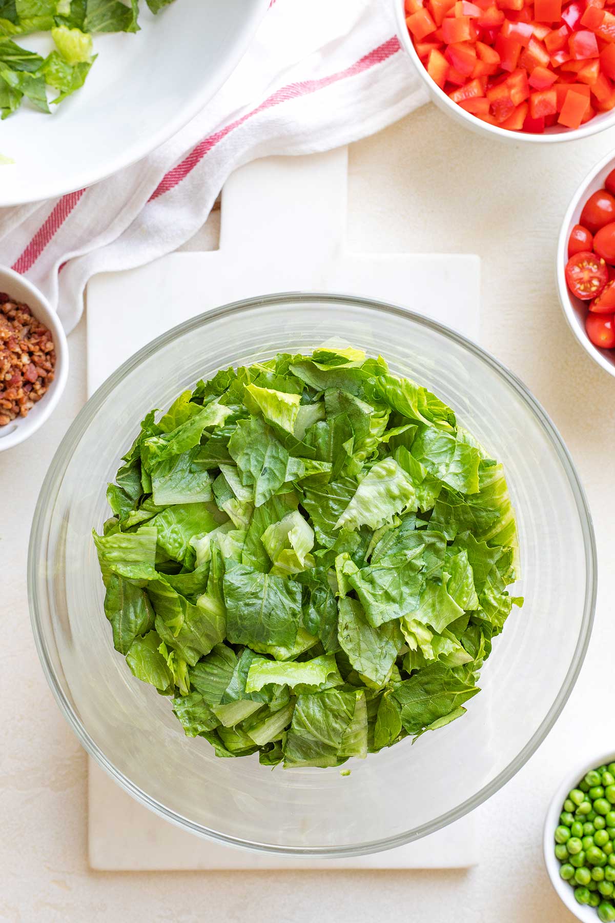 Overhead of layer 1 in salad bowl: romaine lettuce.