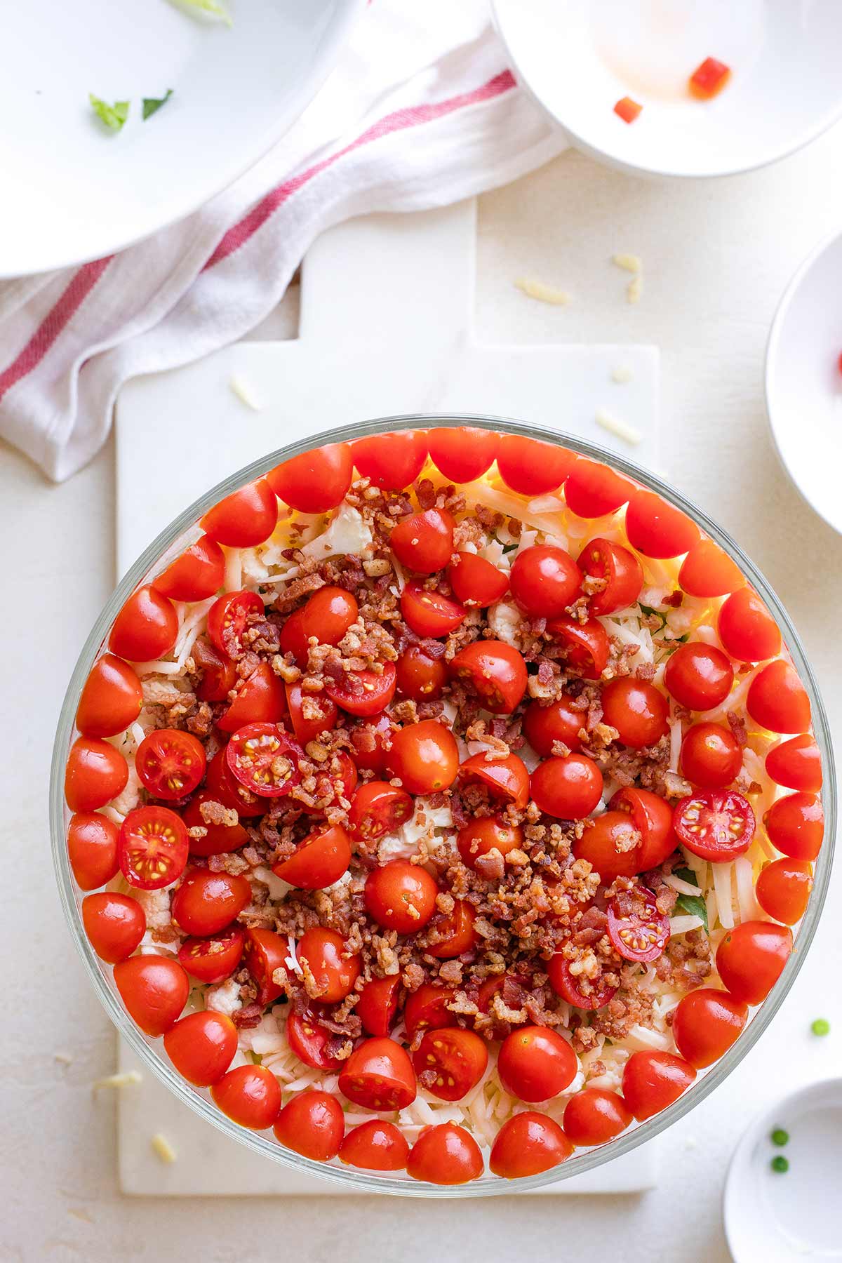 Layer 6: Tomatoes and crumbled bacon.